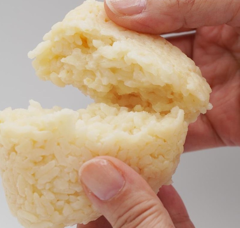 Actual photo of soy sauce-flavored Stockpile Onigiri broken open to show the rice grains